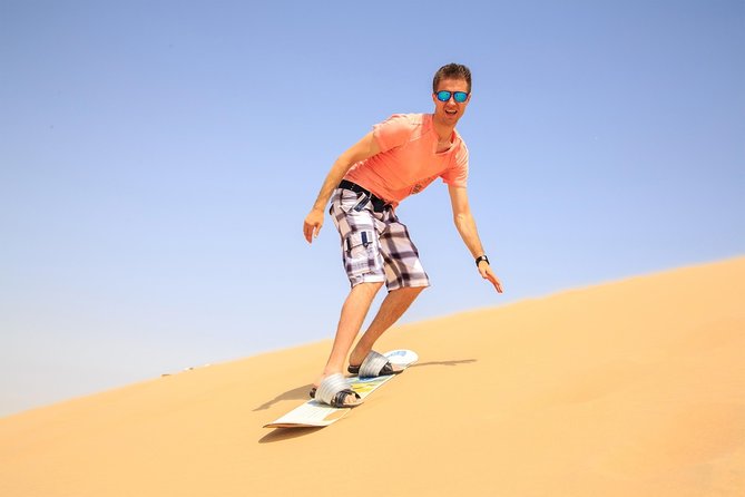 Doha Desert Safari: Dunebashing, Camel, Sandboarding & Inland Sea - Sandboarding on the downhill run
