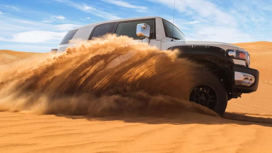 Doha: DesertSafari with Quad Bike, Camel Ride & Sandboarding - Sandboarding down the golden dunes