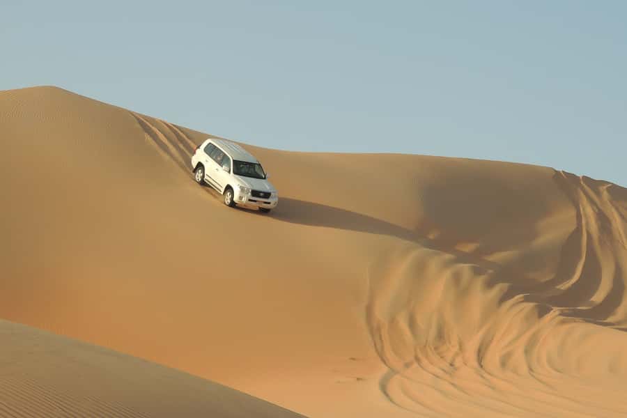Doha Safari: ATV Ride, Dune Bashing, & Sandboarding Fun - Quad biking at the first desert camp