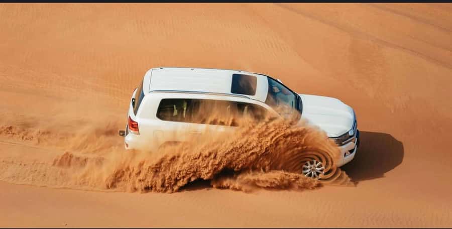 Doha: Safari, Camel Ride, Sand boarding and Inland Sea Tour - Sandboarding down the dunes