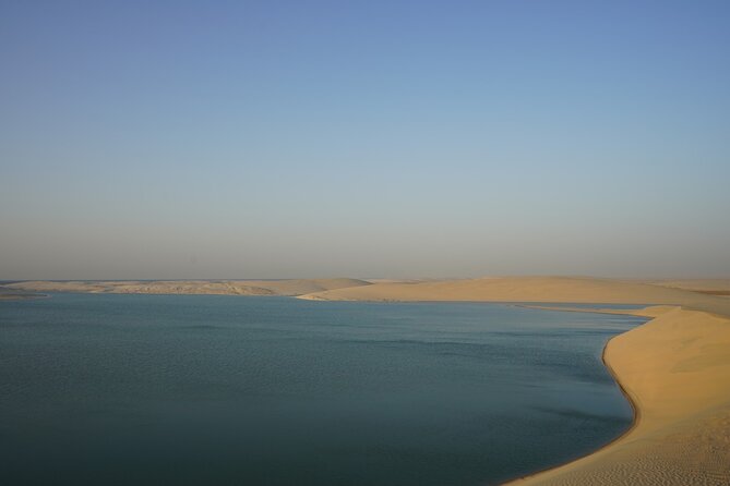 Dunes running down to the tidal water of Khor Al Adaid in southern Qatar